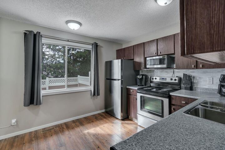 Property Photo: 174 Woodmont Terrace SW AB T2W 4Z4