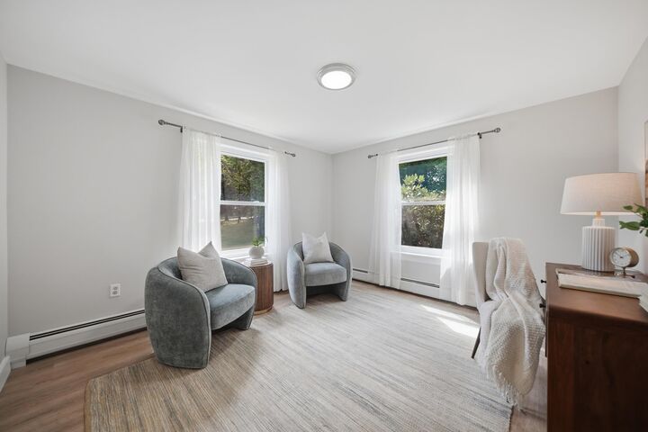 Bonus room with windows and two armchairs at 7 Twin Street, Windham, NH